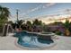 Evening view of a refreshing pool and spa, complete with a waterslide at 156 Ozuna Ct, Las Vegas, NV 89183