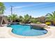 Resort-style backyard oasis featuring a pool, spa, and lush landscaping at 156 Ozuna Ct, Las Vegas, NV 89183