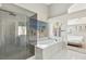 Modern bathroom with a large walk-in shower and a spacious soaking tub at 1713 Sequoia Dr, Henderson, NV 89014