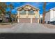 Two-story house with a three car garage and palm trees at 1713 Sequoia Dr, Henderson, NV 89014