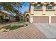 Gorgeous two-story home with a three-car garage and nicely landscaped front yard at 1713 Sequoia Dr, Henderson, NV 89014