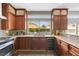 Modern kitchen with wood cabinets, granite counters, and stainless steel appliances at 1713 Sequoia Dr, Henderson, NV 89014