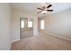 Well-lit bedroom with mirrored closet doors and ceiling fan at 1788 Amarone Way, Henderson, NV 89012