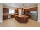 Modern kitchen with granite island and wood cabinets at 1788 Amarone Way, Henderson, NV 89012