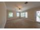 Bright living room with large windows, ceiling fan, and access to a patio at 1788 Amarone Way, Henderson, NV 89012