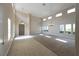 Living room with high ceilings and a combination of tile and carpet floors at 1788 Amarone Way, Henderson, NV 89012