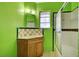 Small bathroom with green walls and shower/tub combo at 2105 Berkley Ave, Las Vegas, NV 89101