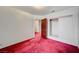 Bright bedroom with red carpet, mirrored closet, and access to hallway at 2105 Berkley Ave, Las Vegas, NV 89101