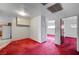 Simple dining area with red carpet and access to other rooms at 2105 Berkley Ave, Las Vegas, NV 89101