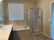 Bathroom with soaking tub, walk-in shower, and updated vanity at 2416 Weaverville Dr, Henderson, NV 89044