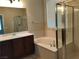 Elegant bathroom featuring a soaking tub, shower, and modern vanity at 2416 Weaverville Dr, Henderson, NV 89044