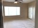 Comfortable bedroom with a ceiling fan, large window, and sliding door access at 2416 Weaverville Dr, Henderson, NV 89044