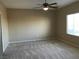 Well-lit bedroom with ceiling fan, neutral carpeting, and window with blinds at 2416 Weaverville Dr, Henderson, NV 89044