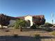 Spanish-style home with desert landscaping and a gravel driveway at 2416 Weaverville Dr, Henderson, NV 89044