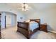 Bright bedroom featuring a wooden sleigh bed and ceiling fan at 2525 Huber Heights Dr, Las Vegas, NV 89128