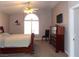 Main bedroom with large window, wooden sleigh bed and dresser at 2525 Huber Heights Dr, Las Vegas, NV 89128