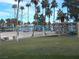 Sand beach area with palm trees, picnic tables, and shade umbrellas at 2525 Huber Heights Dr, Las Vegas, NV 89128