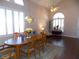 Elegant dining room with hardwood floors, a chandelier, and a view to the living room at 2525 Huber Heights Dr, Las Vegas, NV 89128