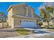 Two-story house with a landscaped yard and attached two-car garage at 2525 Huber Heights Dr, Las Vegas, NV 89128