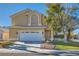 Two-story house with a landscaped yard and attached two-car garage at 2525 Huber Heights Dr, Las Vegas, NV 89128