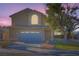 Two-story house with attached garage at dusk at 2525 Huber Heights Dr, Las Vegas, NV 89128