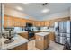 Spacious kitchen with island, stainless steel appliances, and light wood cabinets at 2525 Huber Heights Dr, Las Vegas, NV 89128