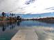 Serene lake view with dock and clouds at 2525 Huber Heights Dr, Las Vegas, NV 89128