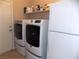 Laundry room with washer, dryer and storage shelves at 2525 Huber Heights Dr, Las Vegas, NV 89128