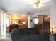 Living room with dark gray couch and view into the kitchen and dining areas at 2525 Huber Heights Dr, Las Vegas, NV 89128