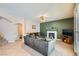 Living room with fireplace, green accent wall, and access to patio at 2525 Huber Heights Dr, Las Vegas, NV 89128