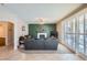 Living room with fireplace, green accent wall, and access to patio at 2525 Huber Heights Dr, Las Vegas, NV 89128