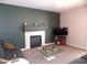 Living room with fireplace, comfortable seating and a large TV at 2525 Huber Heights Dr, Las Vegas, NV 89128