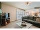 Living room with glass-top coffee table, flat-screen TV and patio access at 2525 Huber Heights Dr, Las Vegas, NV 89128