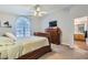 Main bedroom with large window, dresser, and ensuite bathroom at 2525 Huber Heights Dr, Las Vegas, NV 89128