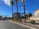 Residential street lined with palm trees and houses at 2525 Huber Heights Dr, Las Vegas, NV 89128