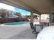 Covered patio with seating area overlooking the pool at 2525 Huber Heights Dr, Las Vegas, NV 89128