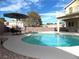 Inviting kidney-shaped pool with patio furniture at 2525 Huber Heights Dr, Las Vegas, NV 89128