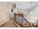 Upstairs hallway with wood railing overlooking the main floor at 2525 Huber Heights Dr, Las Vegas, NV 89128