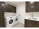 Laundry room with Whirlpool washer and dryer and ample storage at 2623 Turtle Head Peak Dr, Las Vegas, NV 89135