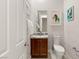 Stylish powder room with granite countertop and wood vanity at 2623 Turtle Head Peak Dr, Las Vegas, NV 89135