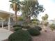 Landscaped backyard with mature trees and patio at 2662 Churchill Cir, Henderson, NV 89074