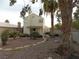 Landscaped backyard with gravel, stone pathway, and palm trees at 2662 Churchill Cir, Henderson, NV 89074