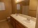 Double sink bathroom with wood cabinets at 2662 Churchill Cir, Henderson, NV 89074