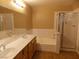 Bathroom with double sinks, bathtub, and shower at 2662 Churchill Cir, Henderson, NV 89074