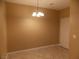 Simple dining room with tile floor and a light fixture at 2662 Churchill Cir, Henderson, NV 89074