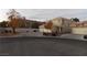 Two-story house with three-car garage and fall foliage at 2662 Churchill Cir, Henderson, NV 89074