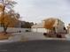 Two-story house with a three-car garage and autumn trees at 2662 Churchill Cir, Henderson, NV 89074