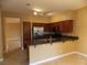 Kitchen with dark wood cabinets, stainless steel appliances and an island at 2662 Churchill Cir, Henderson, NV 89074