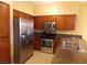 Modern kitchen with stainless steel appliances and wood cabinets at 2662 Churchill Cir, Henderson, NV 89074