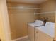 Laundry room with washer and dryer and ample shelving at 2662 Churchill Cir, Henderson, NV 89074